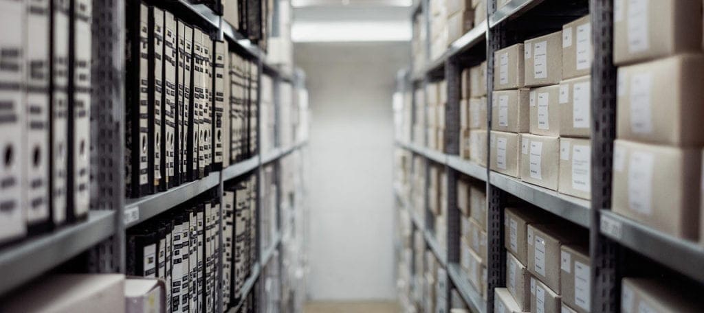 boxes and files stored on shelves in storage facility