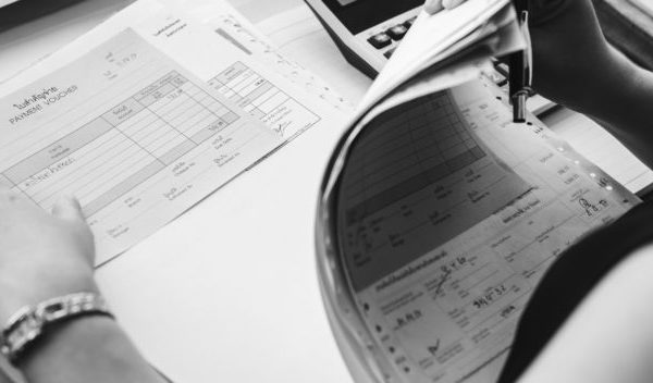 Woman working remotely at desk with paperwork